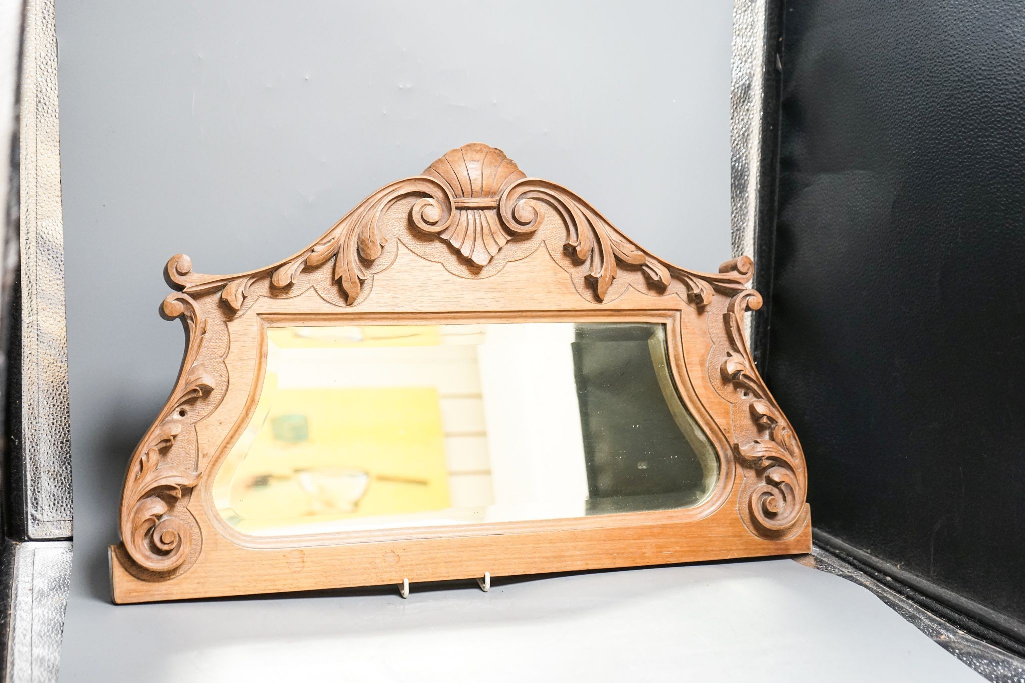 A carved Indian hardwood corbel shaped container, 33 cm, and carved beech mirror frame 59cm